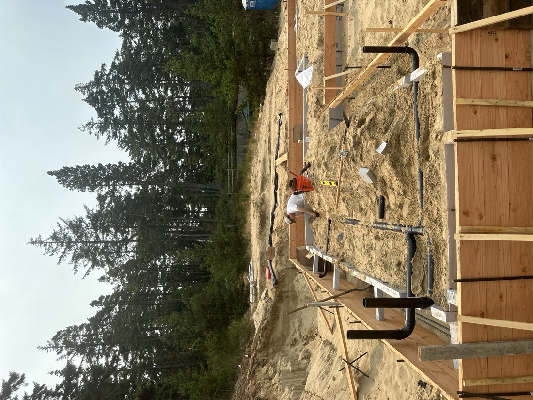Foundation forms and plumbing rough-in on a coastal new construction site